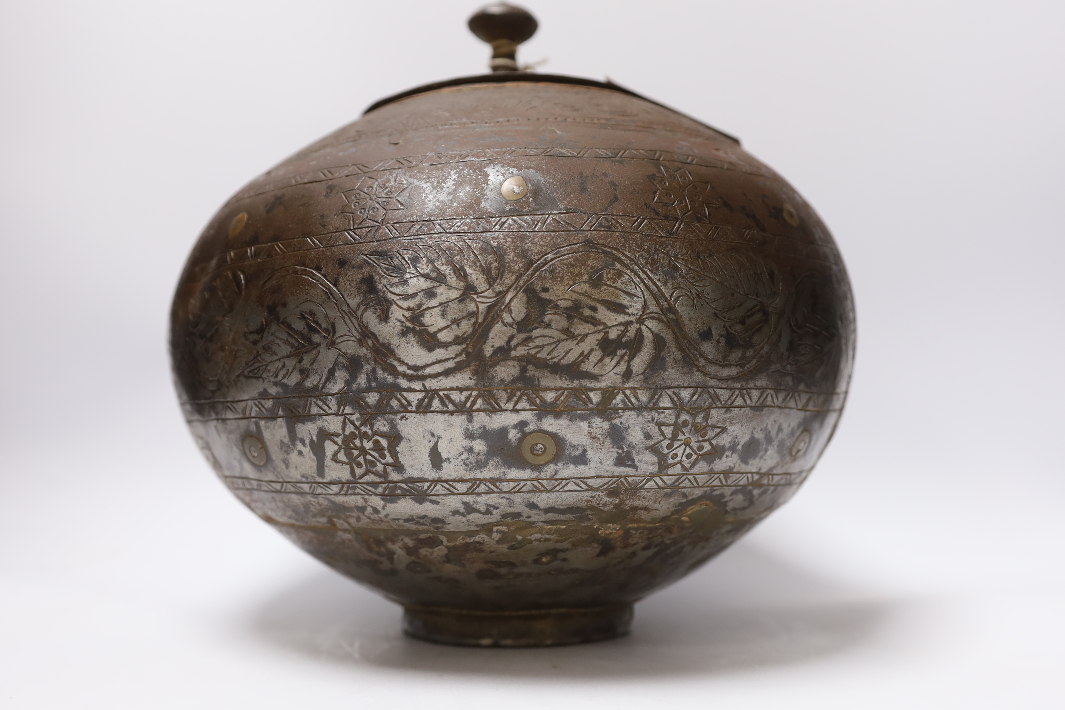 A metal etched eastern squat vase and cover, 32cm high